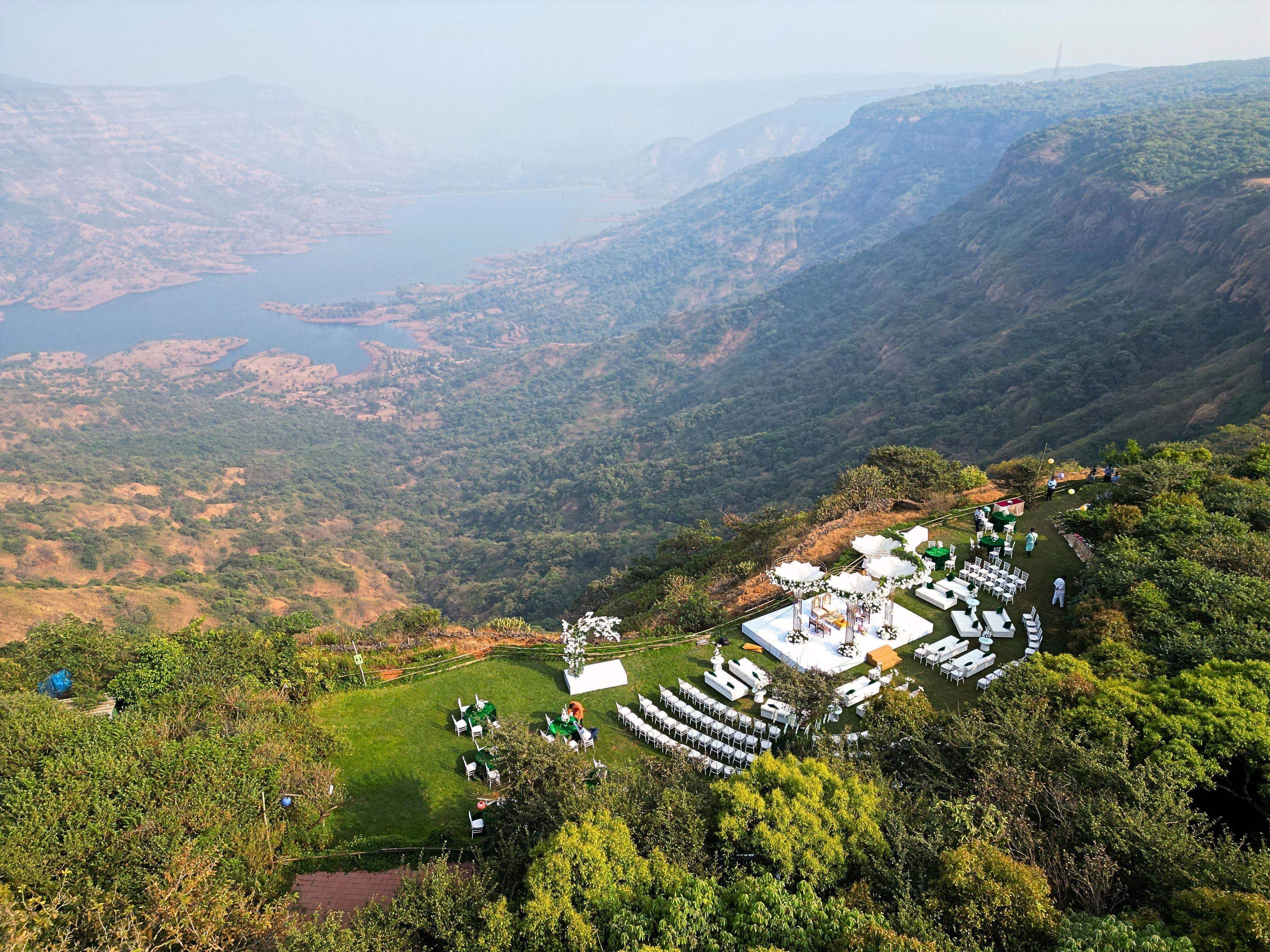 Aerial view of a wedding setup on the edge of a valley at Ramsukh Resort with breathtaking views of the landscape in Mahabaleshwar, Wai, Satara, Maharashtra.